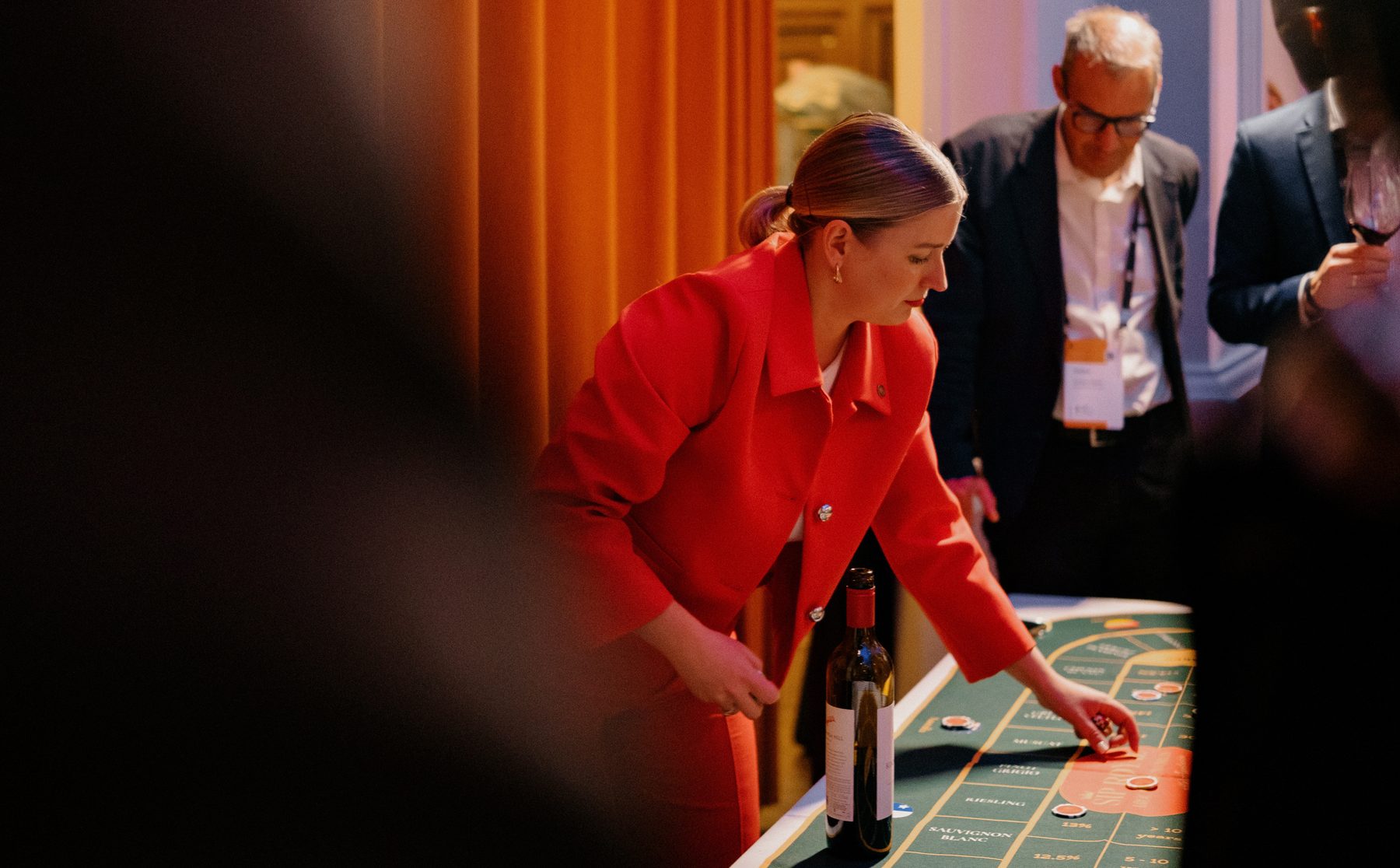 Anastasiia Kornilova hosting a Sip Royal blind tasting, guiding guests as they place their bets at the game table